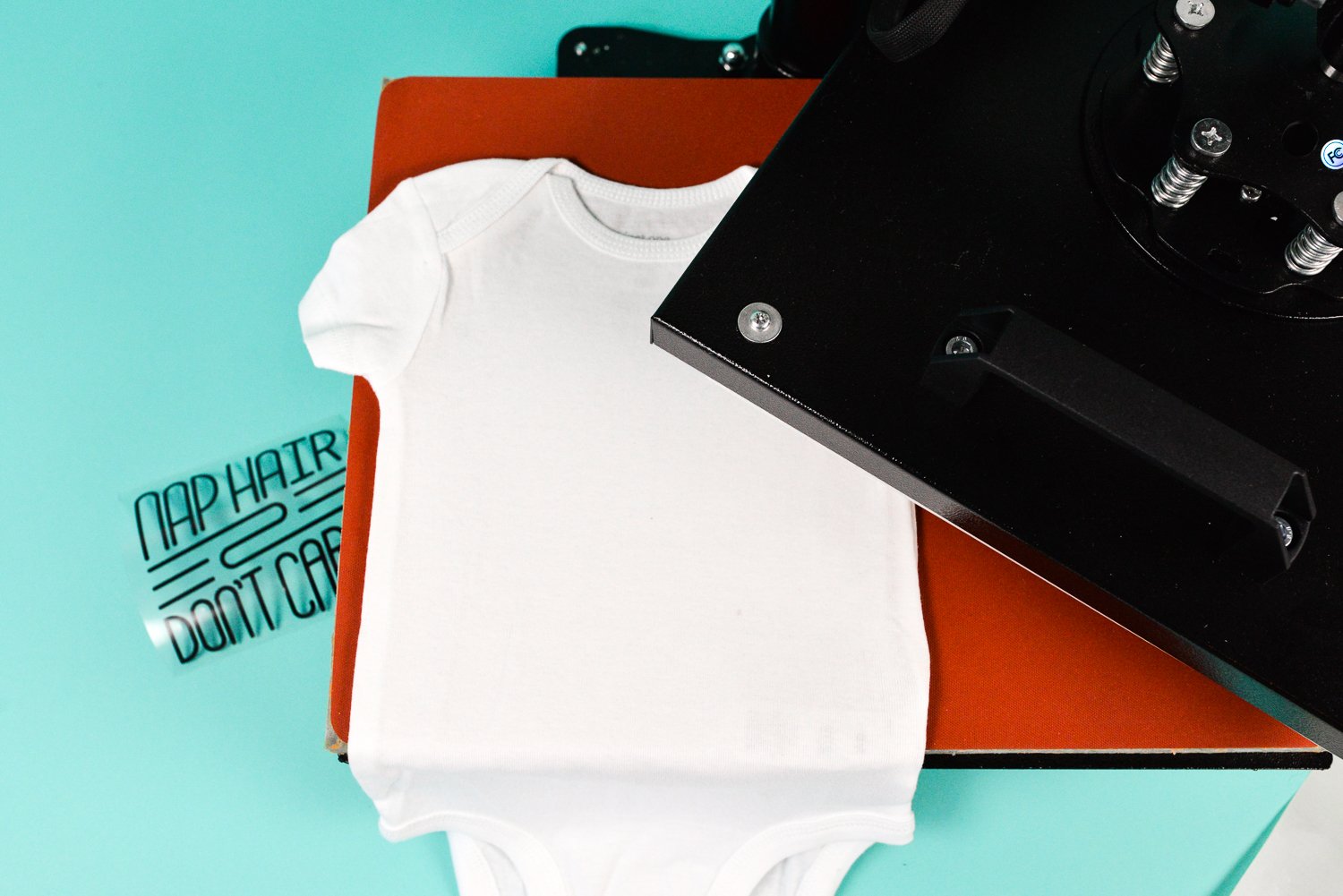place your decal on your bodysuit, do a pre-press with the heat press for about 5 seconds.
