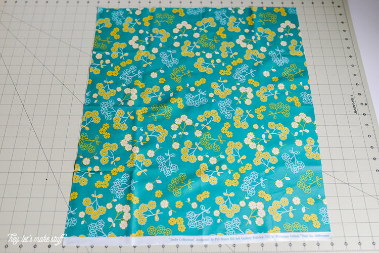 piece of fat quarter fabric laid out on sewing mat