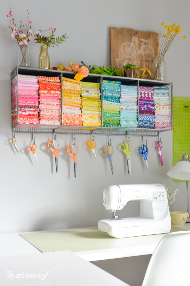 fat quarter fabrics folded up and stacked and organized on the wall