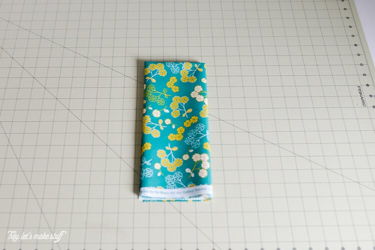 piece of fat quarter fabric folded on a sewing mat