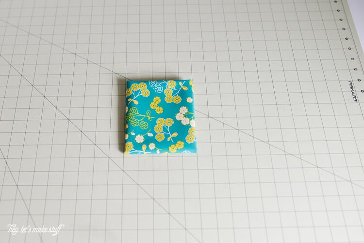 piece of fat quarter fabric folded into a quarter on a sewing mat