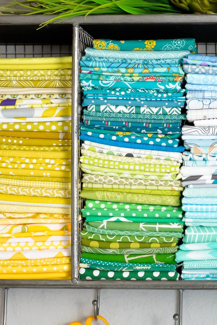 yellow, blue, and green fabric folded into a fat quarter and stacked nicely