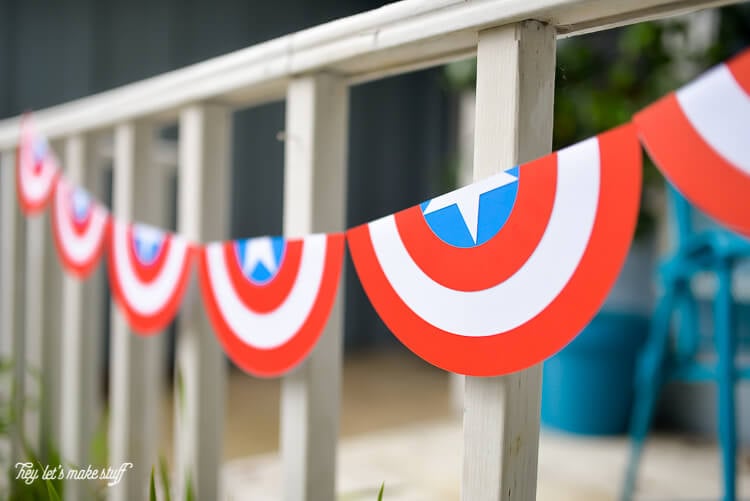 A patriotic bunting hanging from the front porch of a home