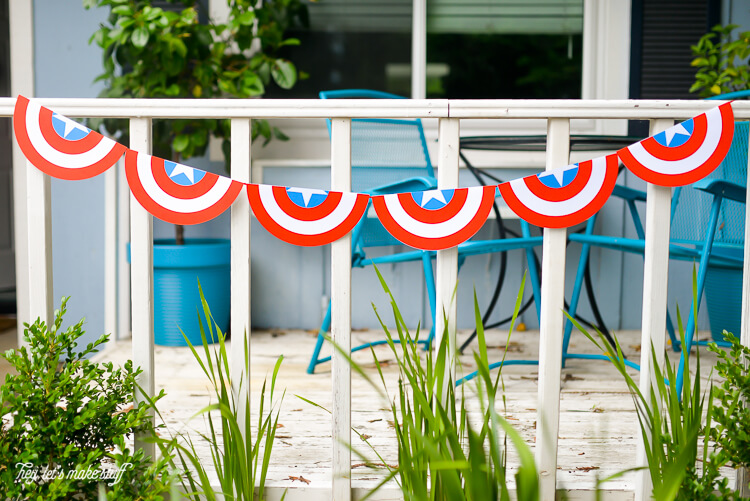 A patriotic bunting hanging from the front porch of a home