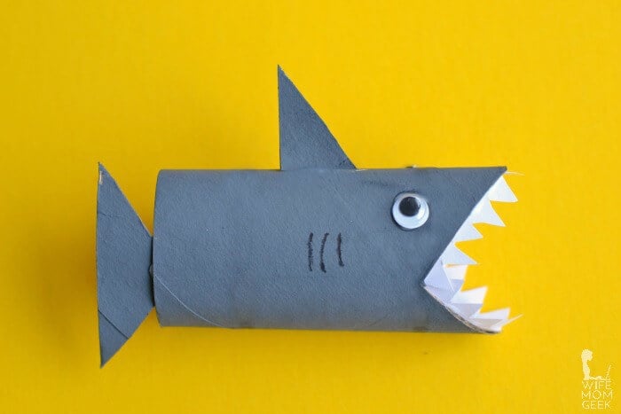 An image of a shark made out of a toilet paper roll