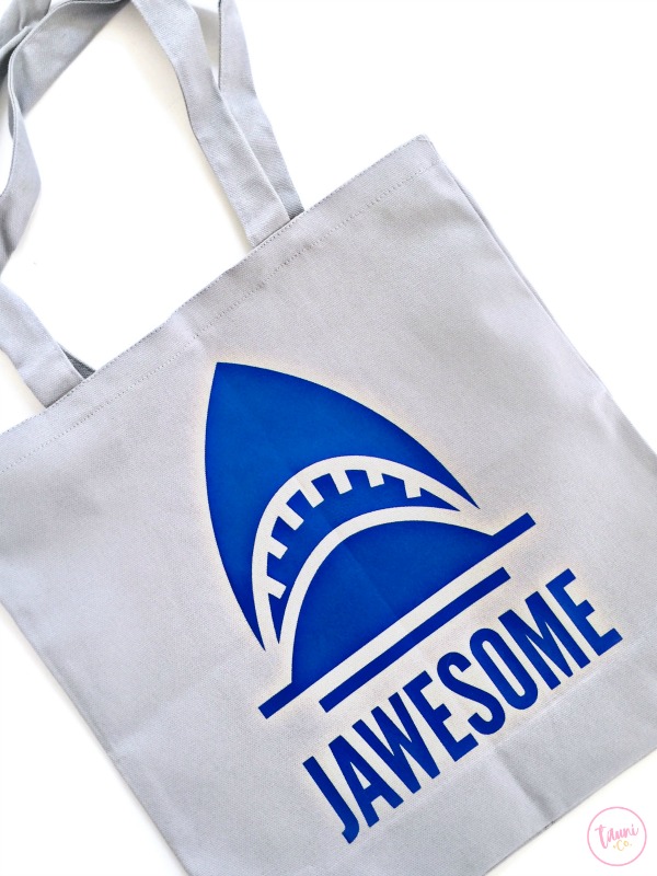A gray canvas bag with an image of a blue shark and the word \"Awesome\" on it