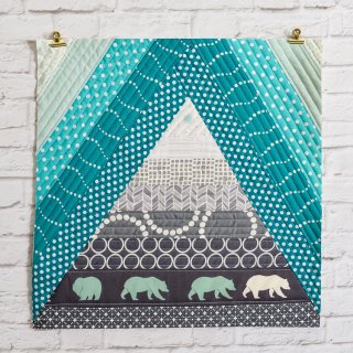 This Bear Mountain quilt-as-you-go (QAYG) block is a fun quilt block perfect for a mountain nursery or any woodland decor!