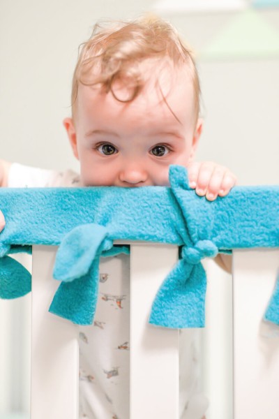 Baby chewing on the rails of his or her crib? Make these easy, no-sew fleece crib rail covers to protect the crib and your baby's teeth!