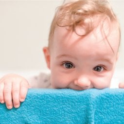 Baby chewing on the rails of his or her crib? Make these easy, no-sew fleece crib rail covers to protect the crib and your baby's teeth!