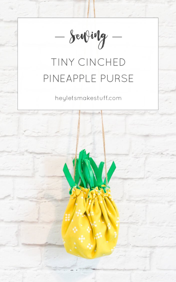 A pineapple purse hanging on a white brick wall with advertising for - Sewing - Tiny Cinched Pineapple Purse from HEYLETSMAKESTUFF.COM