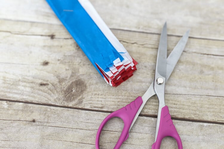 make tissue paper fireworks - cut fringe on both sides