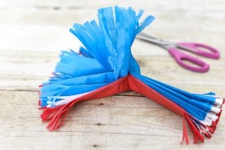 Red, white, and blue tissue paper explode in brilliant fireworks, perfect as easy Fourth of July party decor!