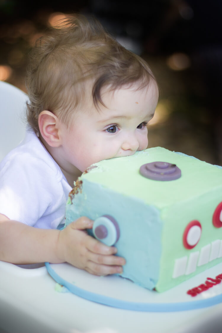 A baby eating a cake