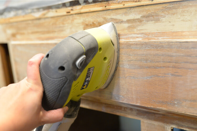 sanding the kitchen cabinets