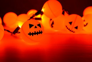 Orange ping pong balls plus fairy lights equal a fun Halloween Jack O' Lantern decoration! An easy project anyone can do.