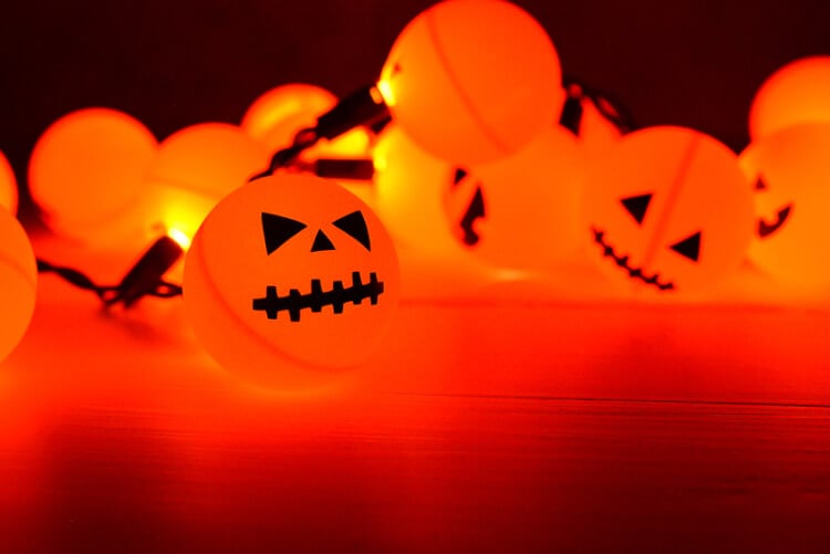 Orange ping pong balls plus fairy lights equal a fun DIY Halloween Jack O' Lantern decoration! 