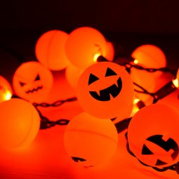 Orange ping pong balls plus fairy lights equal a fun Halloween Jack O' Lantern decoration! An easy project anyone can do.