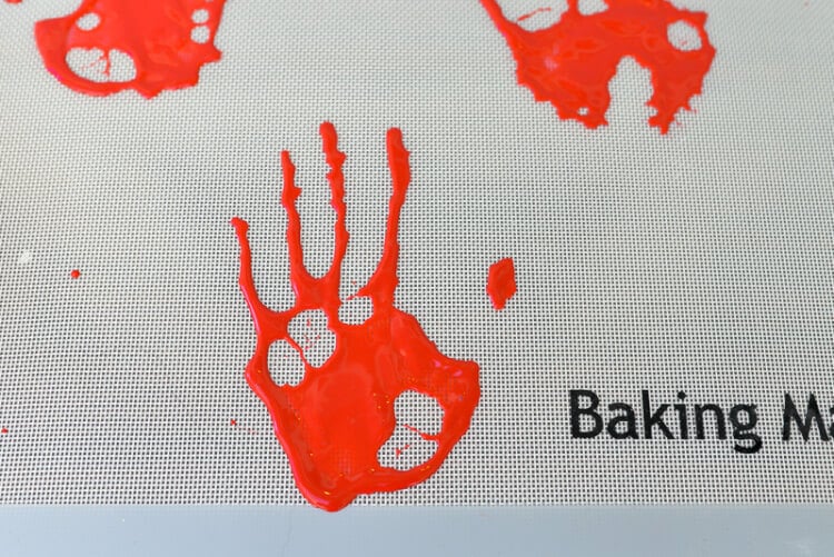 Images of bloody handprints on a baking mat