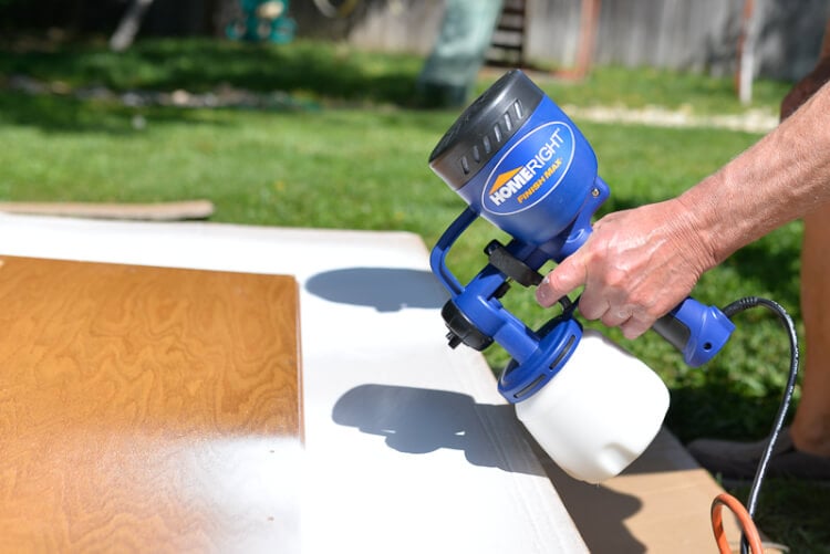 using a sprayer to paint kitchen cabinets