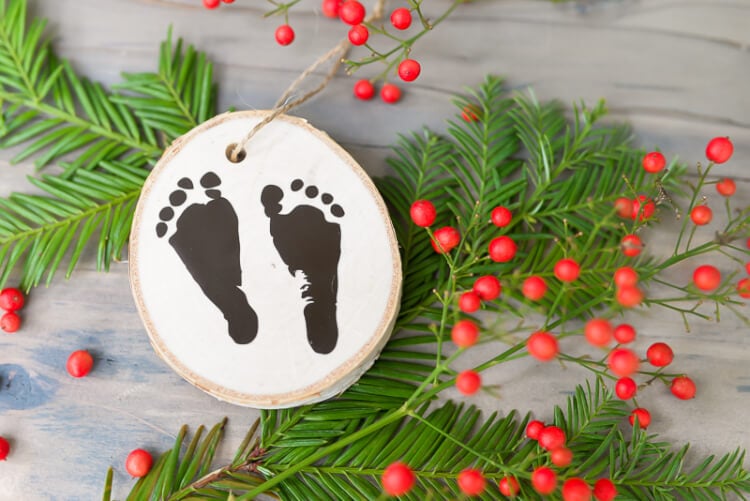 Use your Cricut Explore or other cutting machine to easily cut your newborn's footprints out of vinyl to make a sweet keepsake ornament.