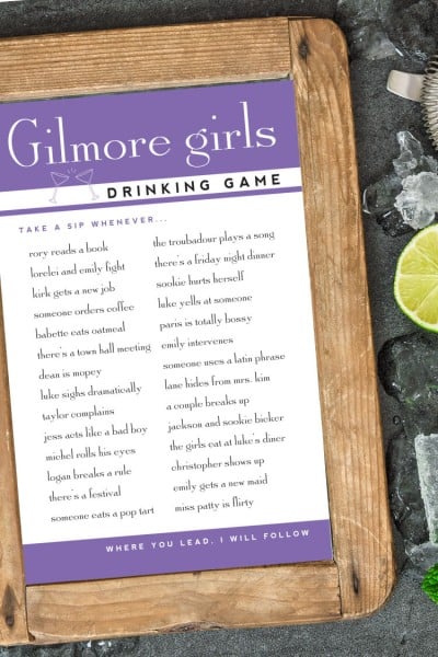 A piece of paper for a Gilmore Girls drinking game lying on top of a piece of wood on a table