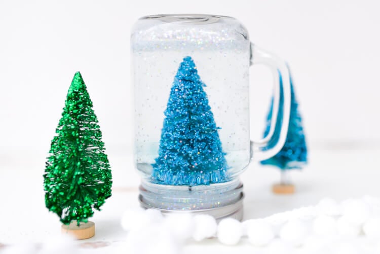 A miniature bottlebrush tree inside of an upside-down Mason Jar sitting on a table