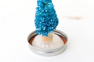 Make a glittery Mason Jar Snow Globe for Christmas this year! A great winter craft to make if you aren't expecting a White Christmas where you are. Can be used as a calm jar, too!