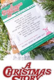 A piece of paper that contains a printed image of A Christmas Story Drinking Game laying on top of a table with holiday greenery on it with advertising from HEYLETSMAKESTUFF.COM for A Christmas Story Drinking Game 