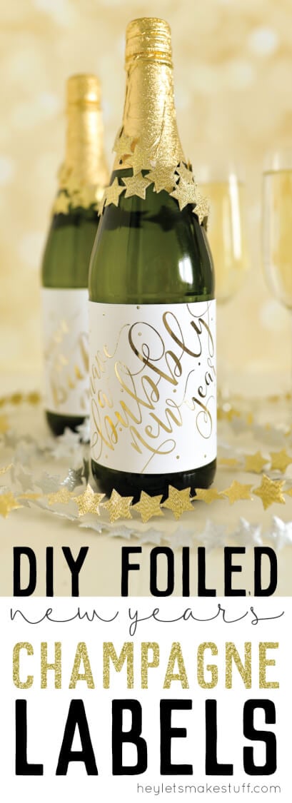 Two bottles of champagne and two champagne flutes sitting on a table surrounded by garlands of silver and gold stars with advertising for DIY foiled New Year\'s champagne labels by HEYLETSMAKESTUFF.COM