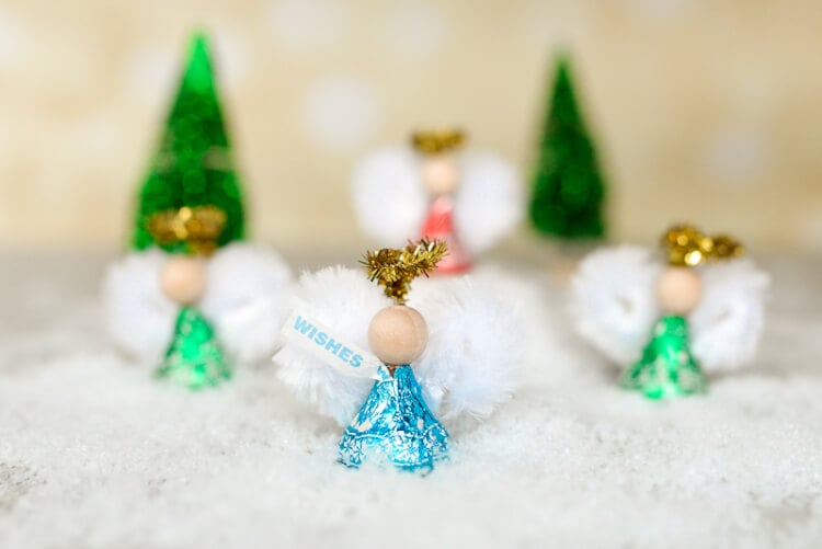 Four Hershey\'s kisses decorated to be angels
