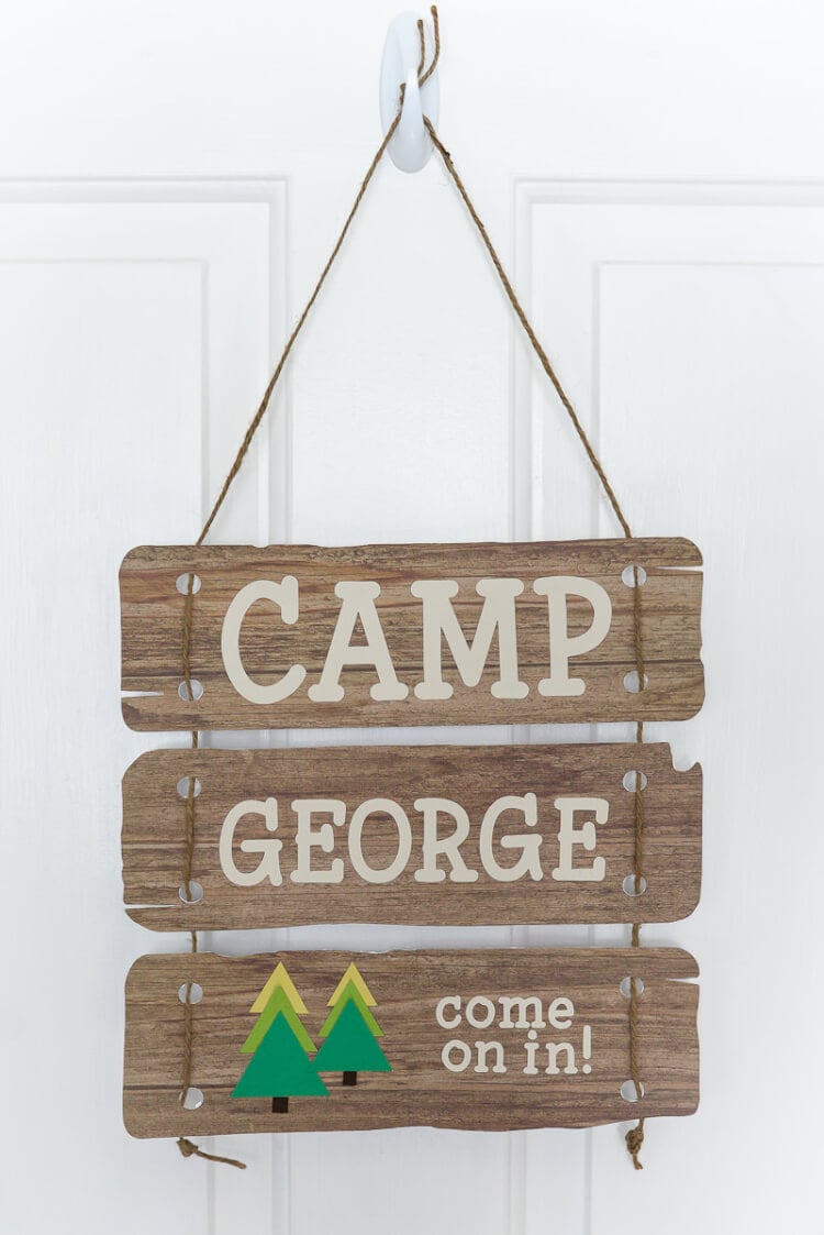 A close up of a sign on a door, and the sign says, \"Camp George Come on In!\"