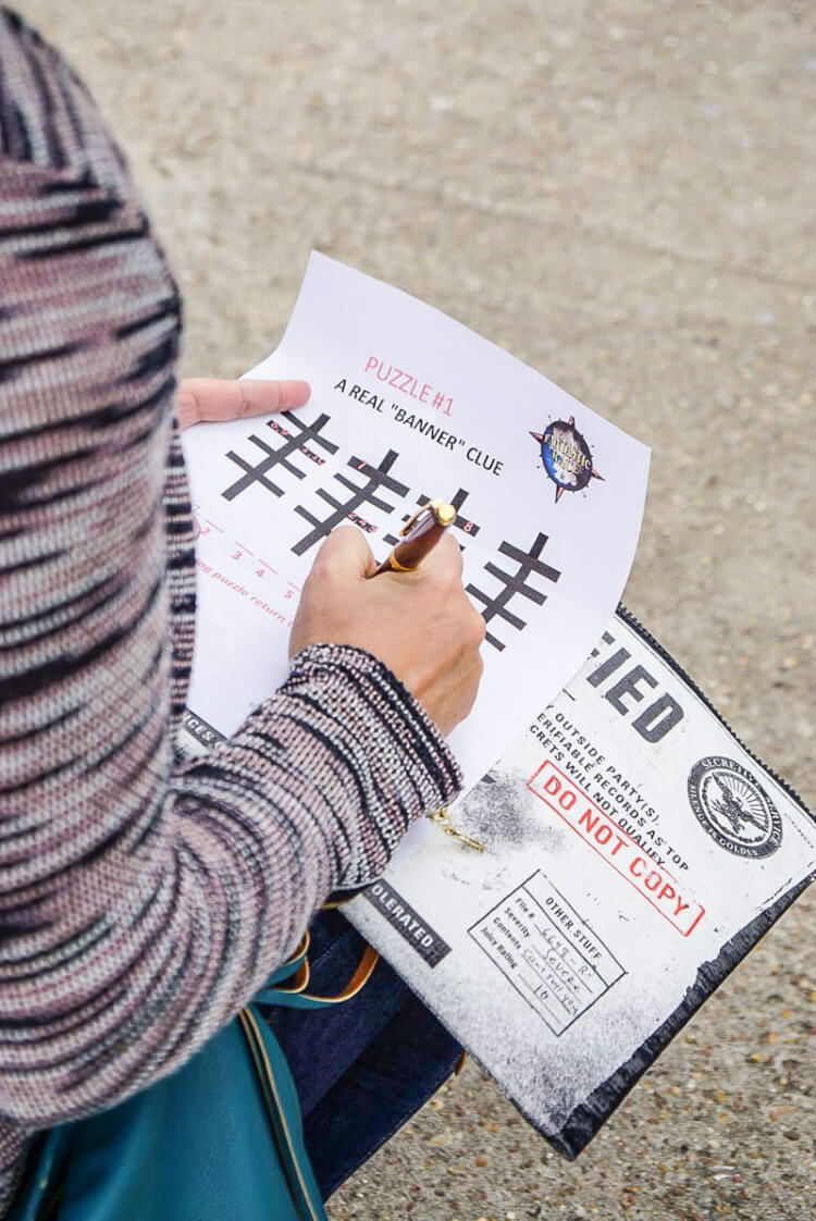 A close up of a person holding a of a piece of paper and a pen