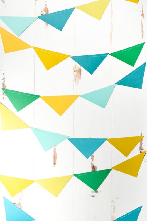 Colorful paper pennants hanging from a wall