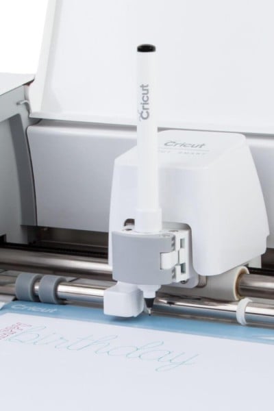An image of a Cricut machine with the writing pen loaded
