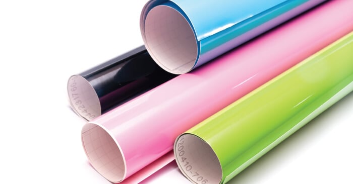 Black, blue, pink and green rolls of vinyl