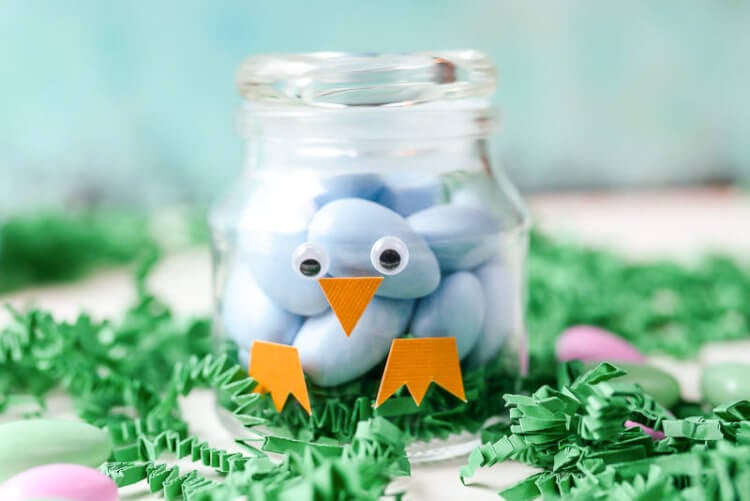 A close up of a jar decorated to resemble a bird