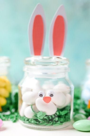 Make these adorable DIY Easter Jars using a simple spice jar and paper! Fill with candy or other goodies to make the perfect Easter basket stuffer.