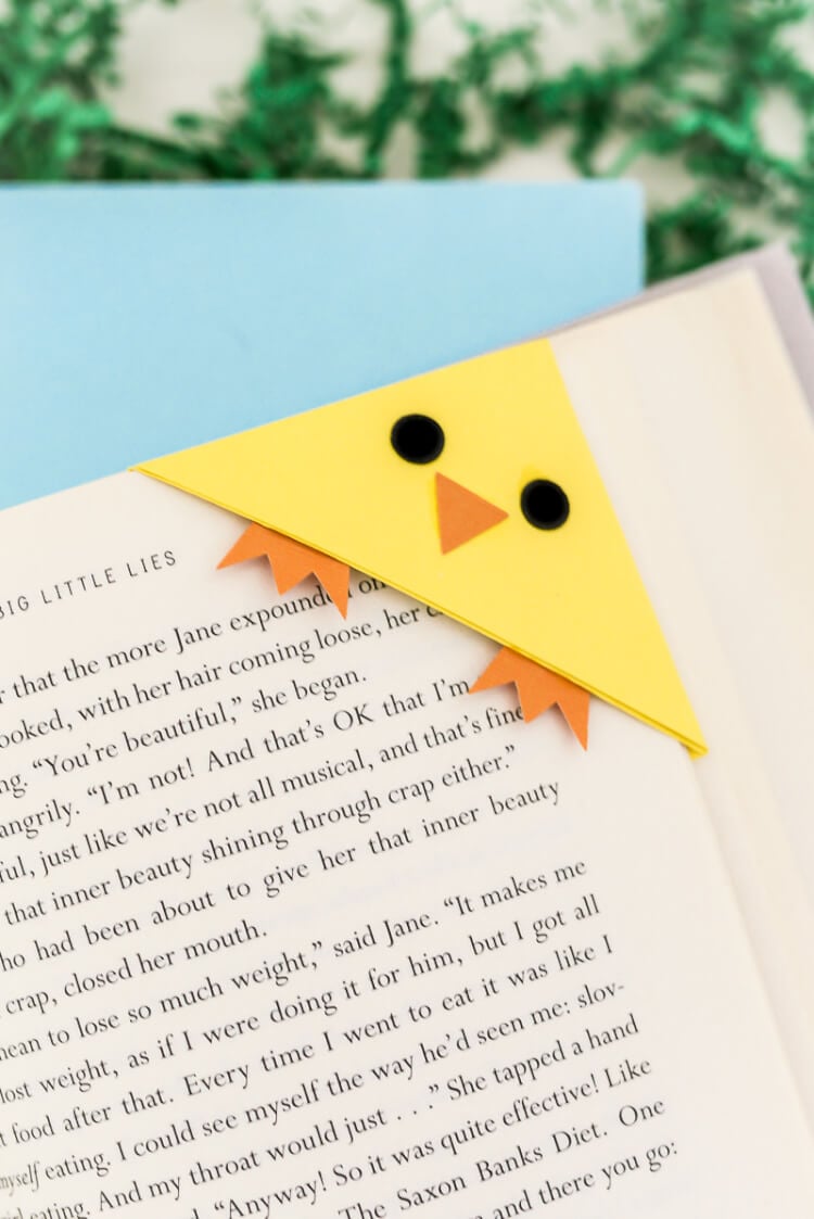 Close up of a chick bookmark over the corner of a book