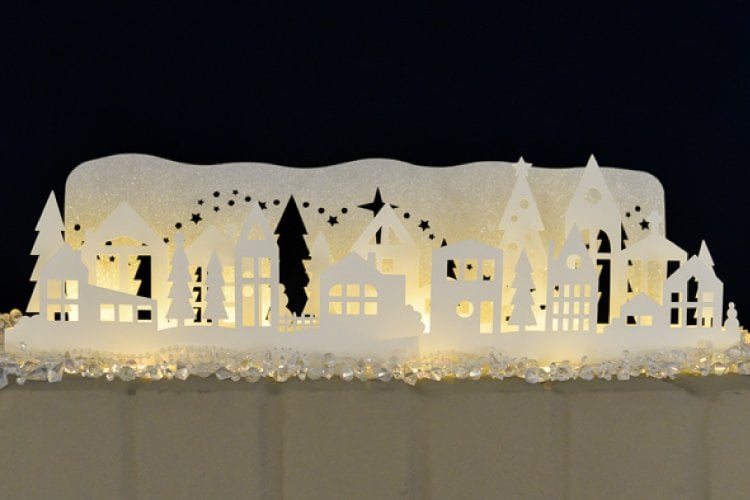 A Christmas themed luminaria cut from paper