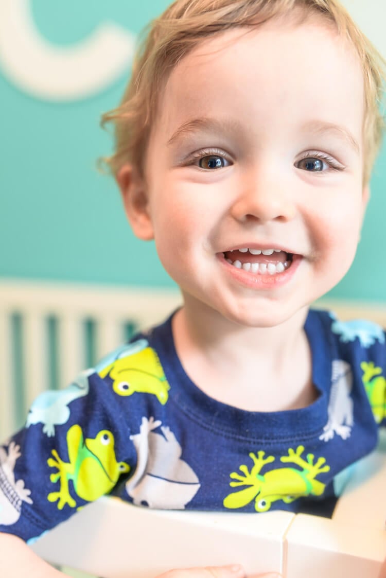 A young child smiling at the camera