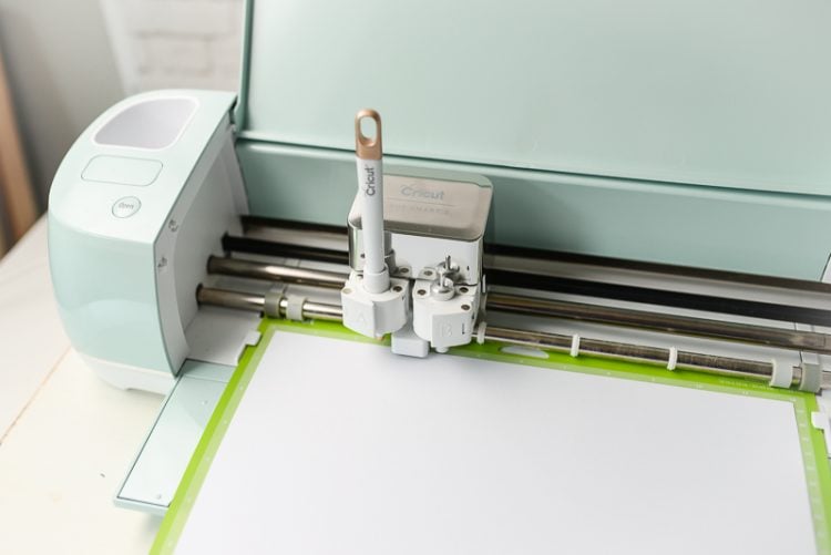 Cricut Machine with a tool and a mat loaded