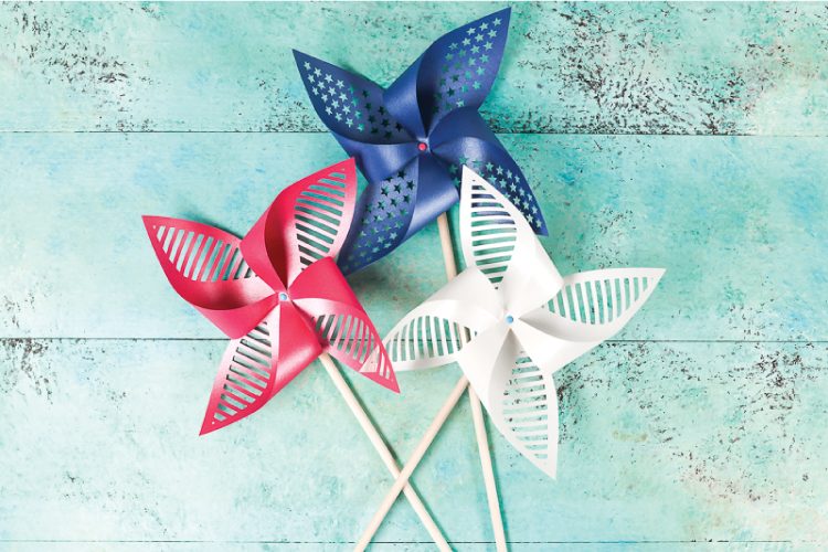 Three pinwheels, one blue, one white and one red