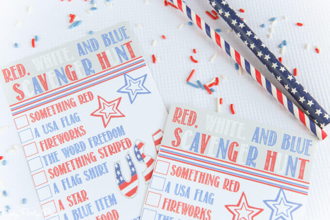 Two patriotic designed pencils and two pieces of paper with a printed red, white and blue scavenger hunt list