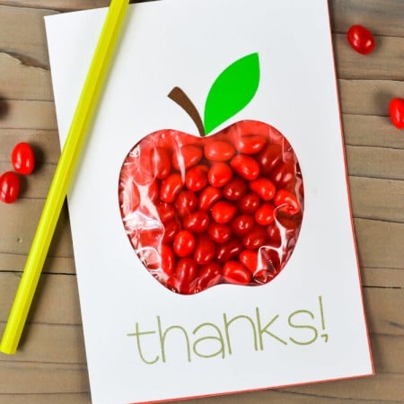 A thank you card with an apple candy pouch on it