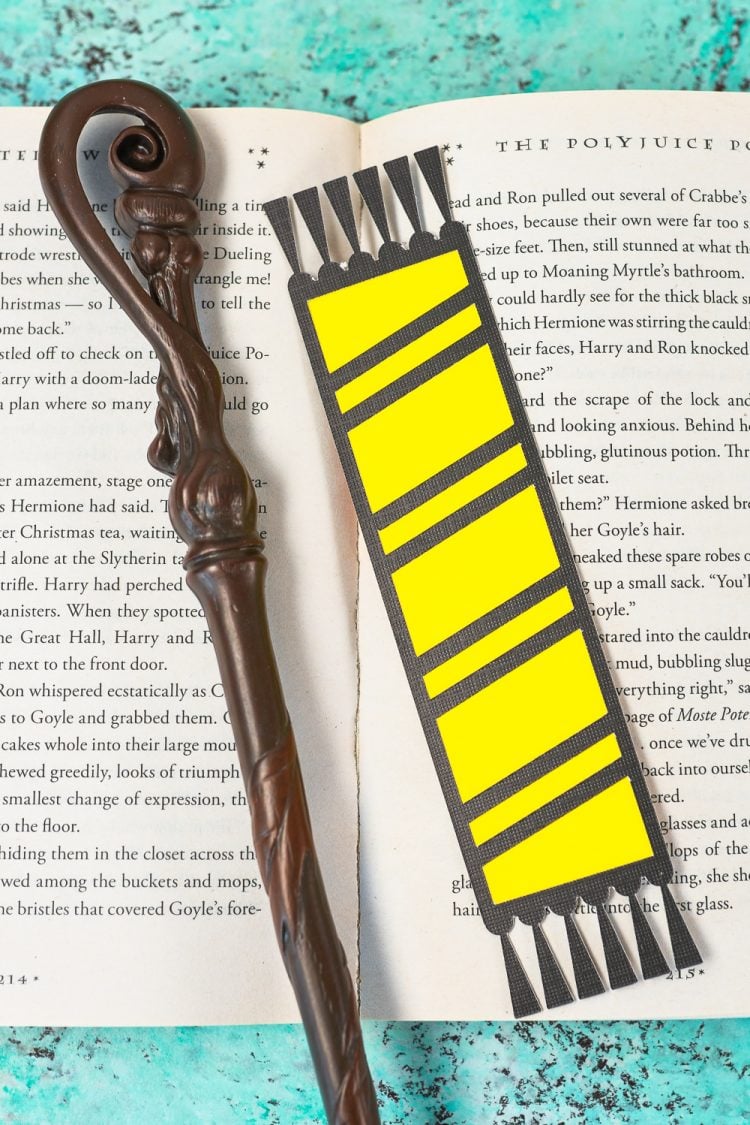 Hogwarts house bookmarks on book - Slytherin