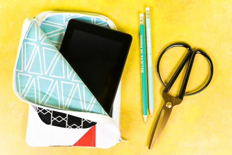 Two pencils, a pair of scissors, and a tablet inside of a decorated tablet case