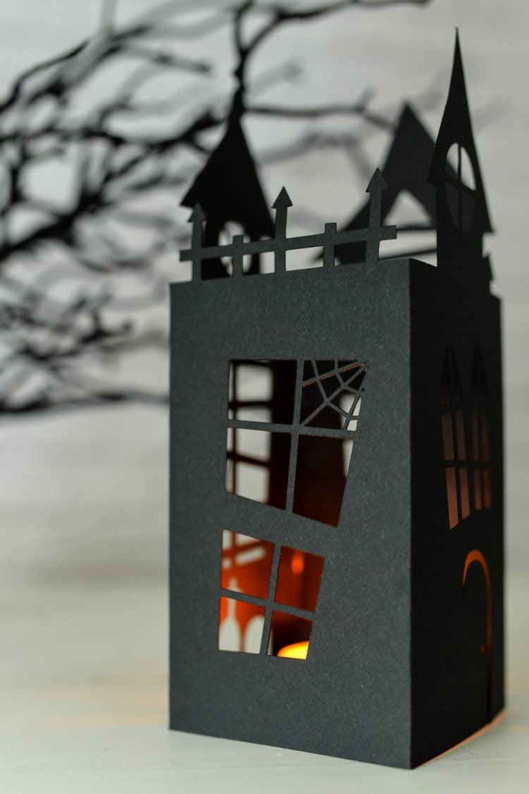 A side view of a Halloween haunted house lantern cut from paper