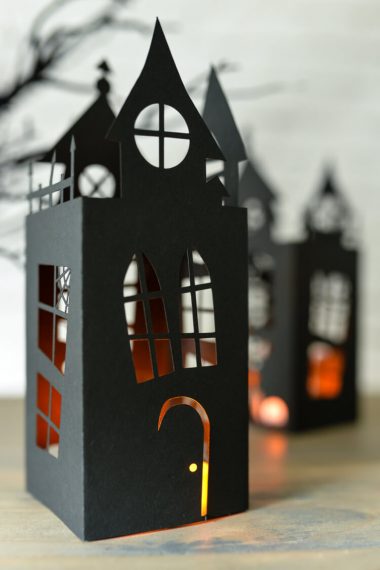 A Halloween haunted house lantern cut from paper