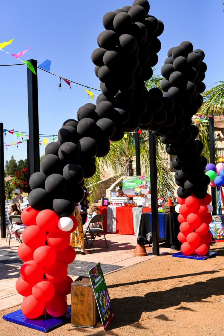 A giant Mickey balloon archway as entrance to a party