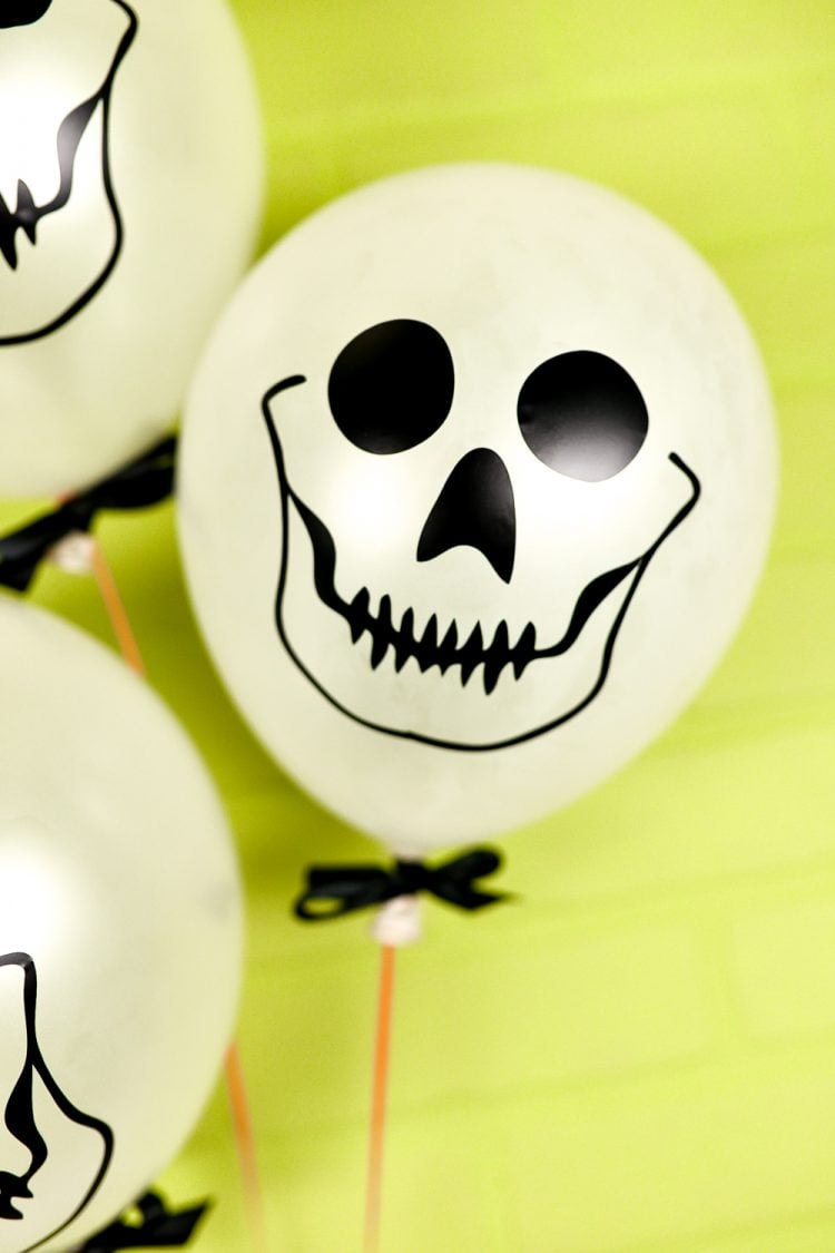Close up of white balloons decorated with skulls
